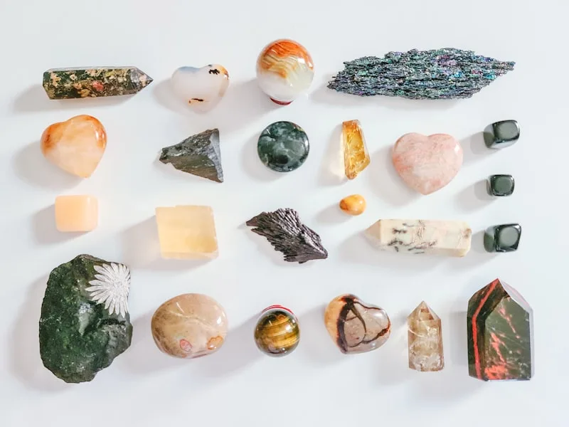 A small collection of natural crystals arranged on a neutral linen cloth, soft daylight