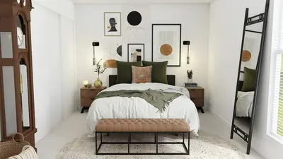 A round mirror on a light-colored wall reflecting a green plant and natural light from a nearby window