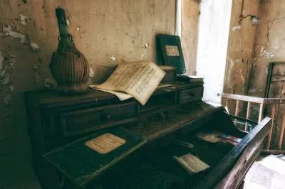 An open book on a wooden desk with simple, clean typography visible on the pages